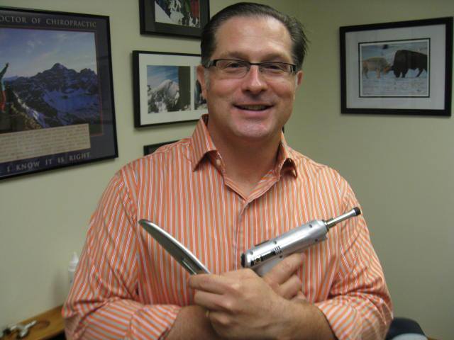 Dr. Pokowicz holding adjusting tools